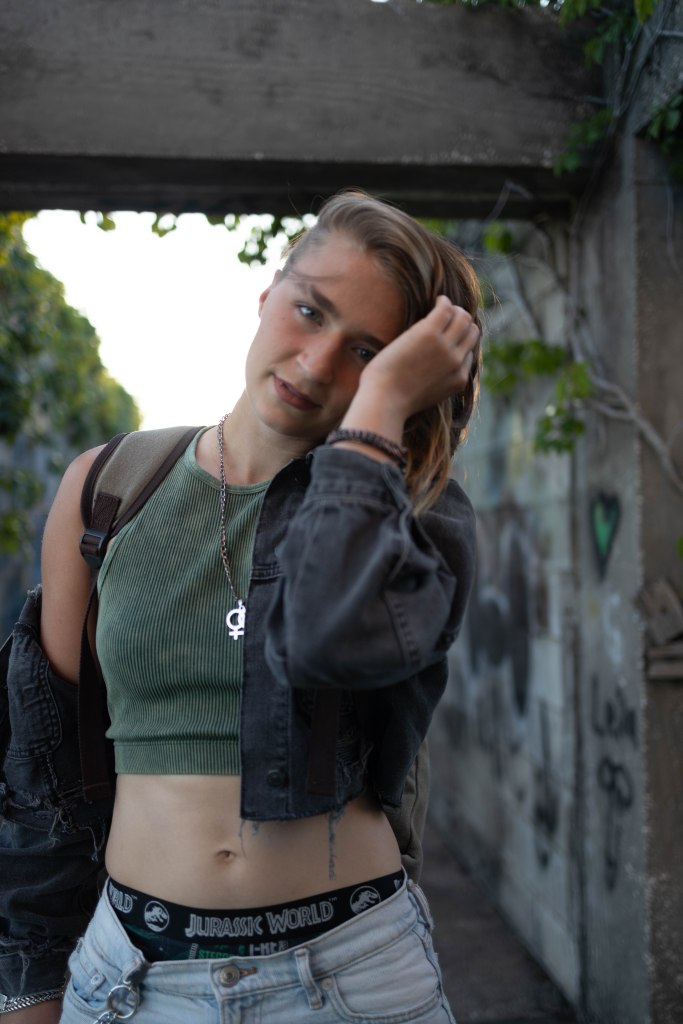 Gray pushing her hair out of her eyes and smiling