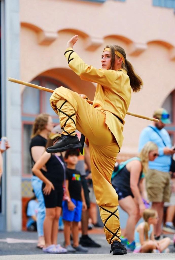 Gray in the Universal Mega Film parade in costume with her bo staff