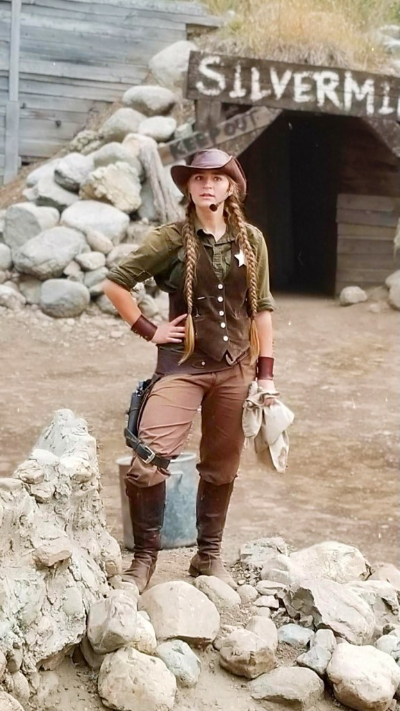 Gray in an old west costume performing in the Silverwood stunt show