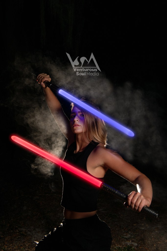 Gray posing with lightsabers 